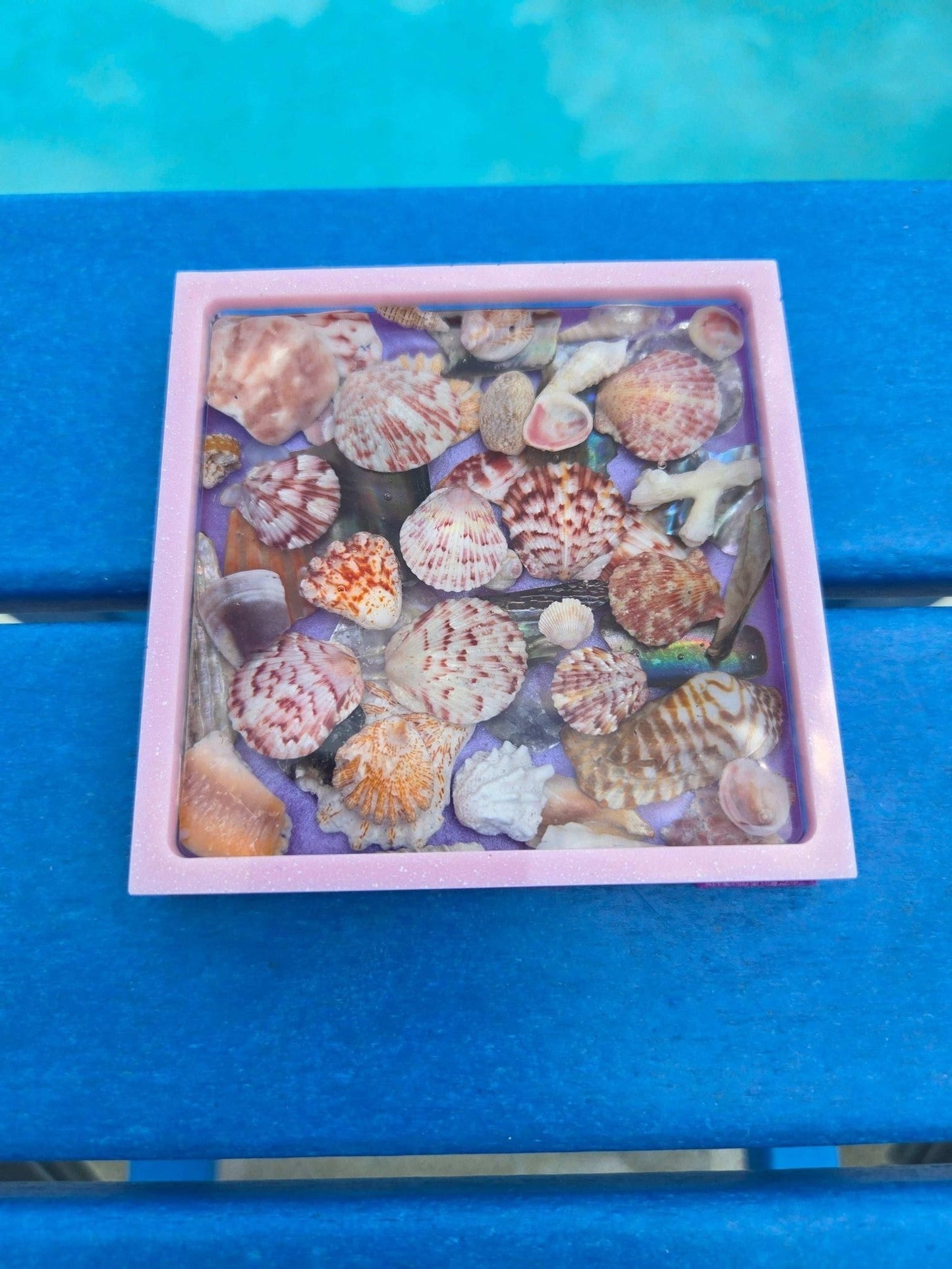 Resin coaster with assorted seashells in ocean hues, handmade