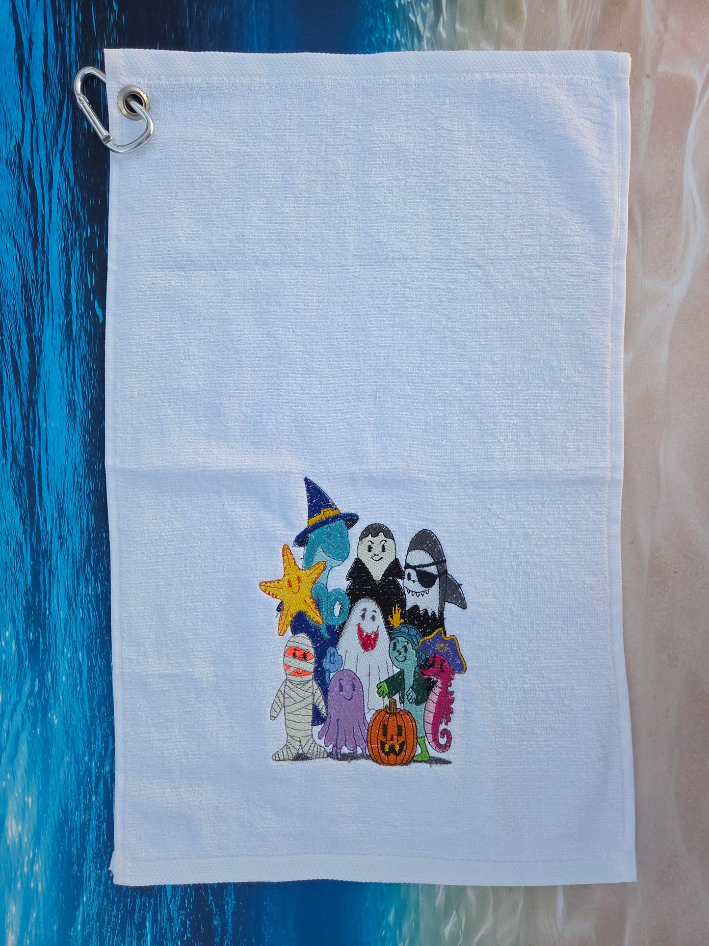 Embroidered pouch with cartoon characters on a blue surface