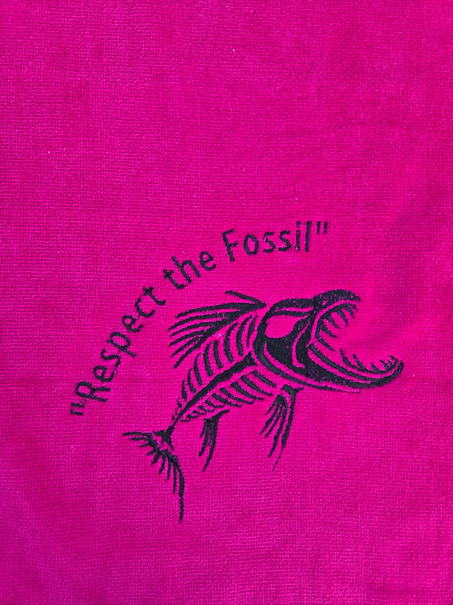 hot pink terry towel with Respect the Fossil embroidery, brass grommet and silver clip ring