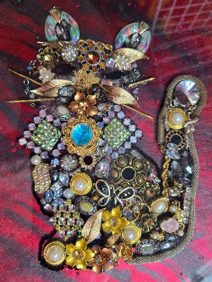 Handcrafted resin jewelry piece inspired by Remy the cat, with beach charms and vintage jewels