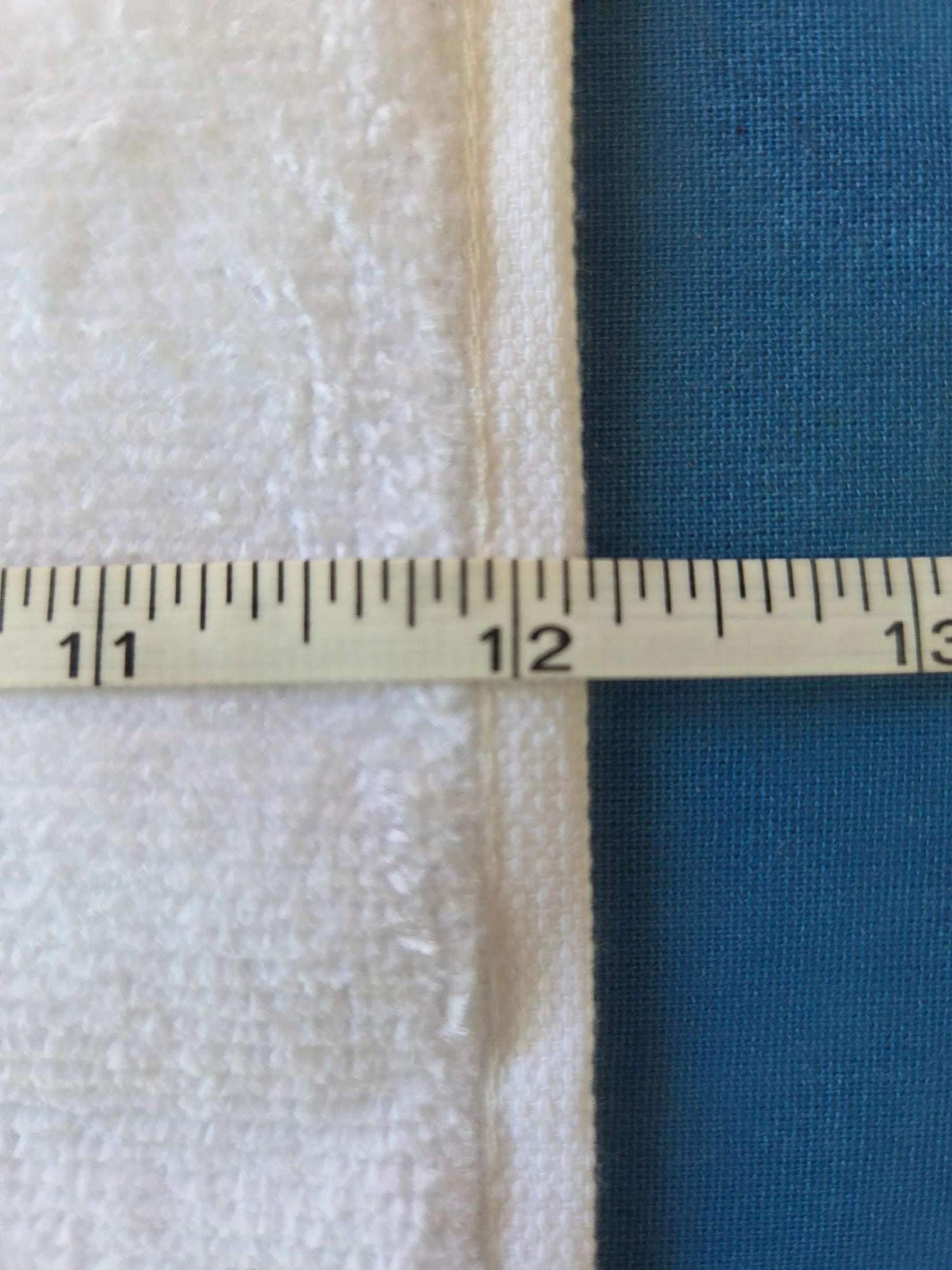 Measurement of fabric with a ruler showing 12 inches