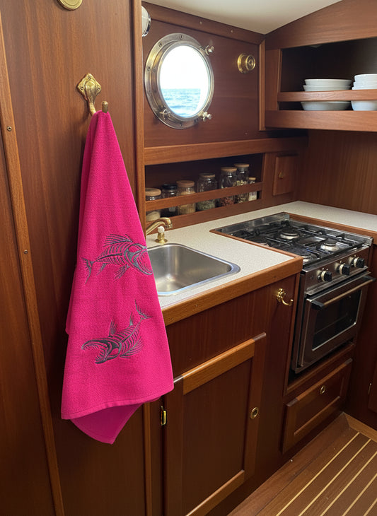Pink fabric with black embroidered designs of fish skeletons