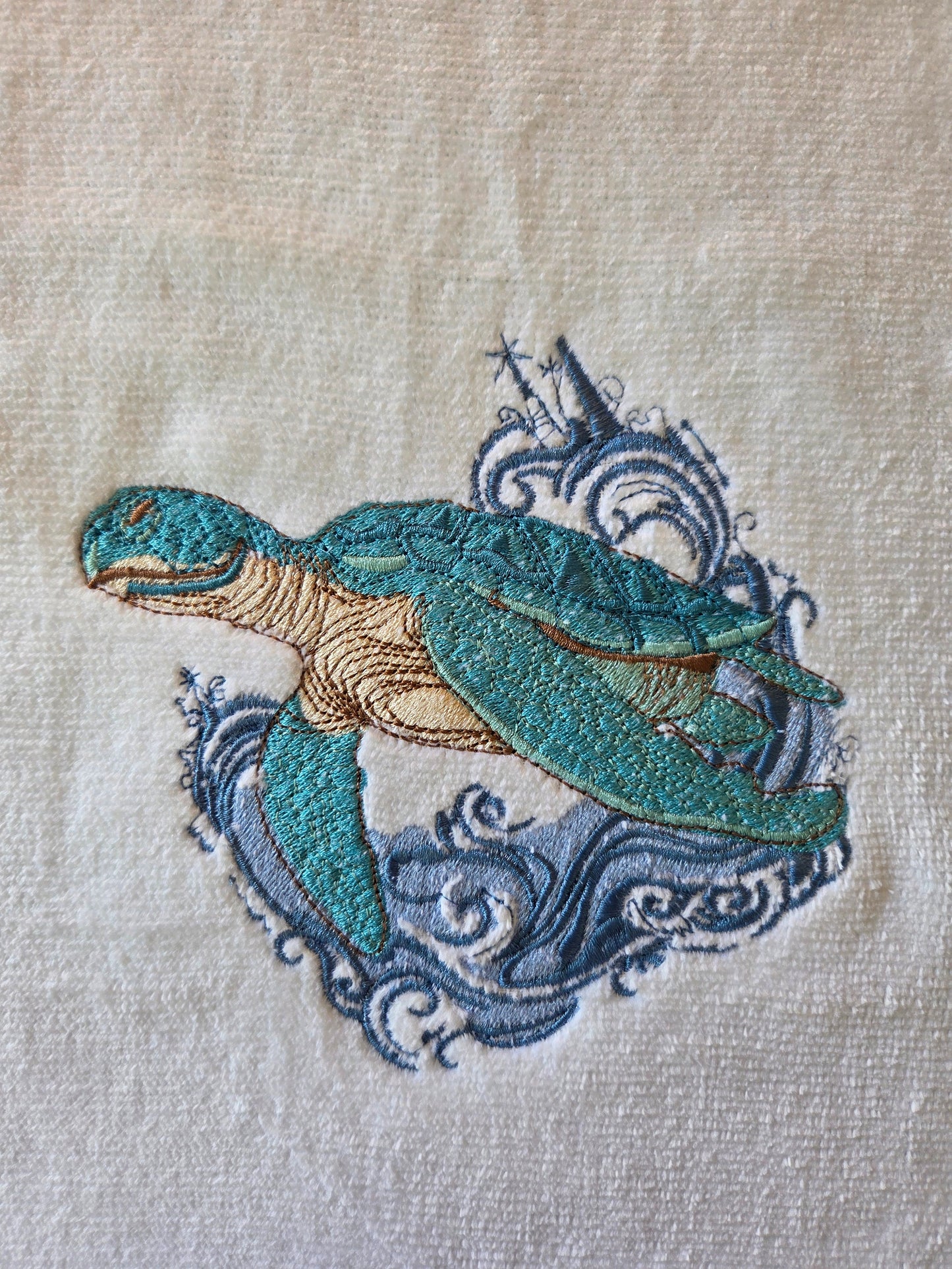 Embroidered peacock design on fabric with a beige background