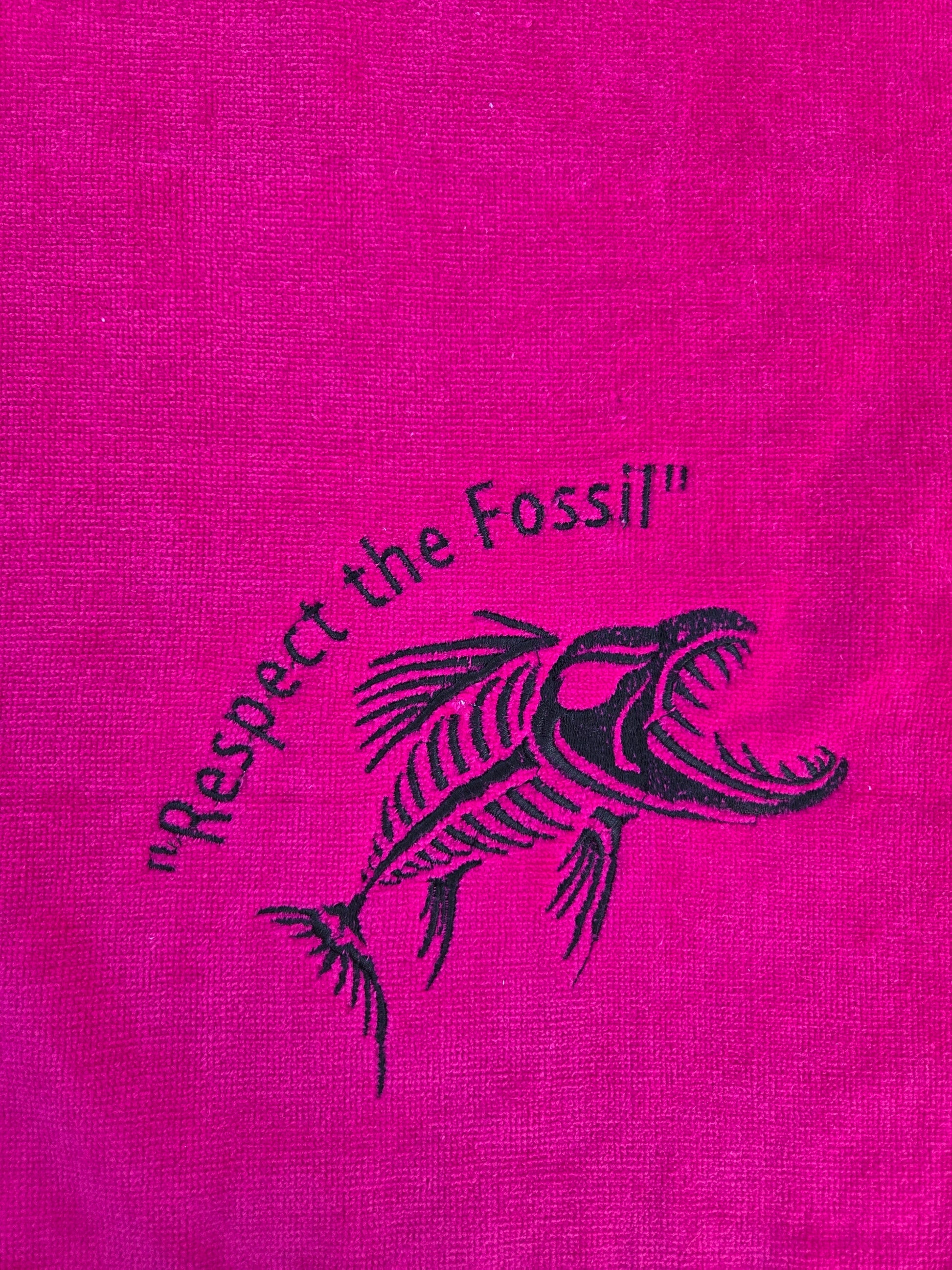 hot pink terry towel with Respect the Fossil embroidery, brass grommet and silver clip ring